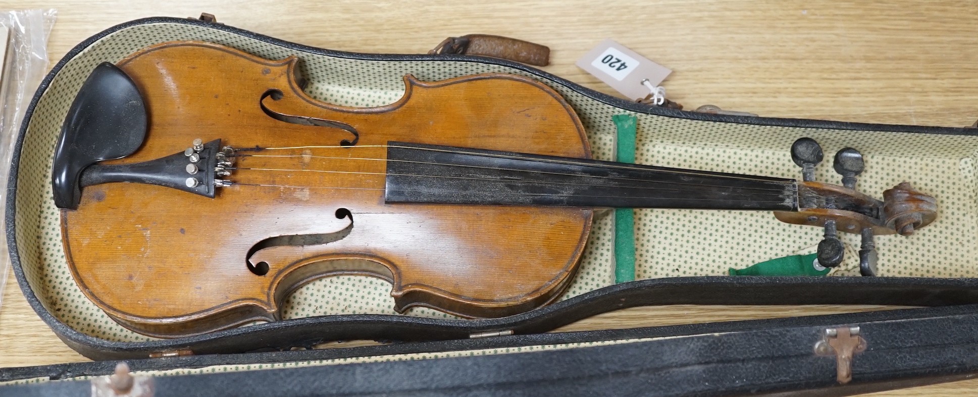 A cased violin, interior label reads ‘copy of Antonius Straduarius made in Germany’, back measures 35.5cm